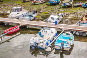 Boats  in a little harbor during an outflow, low water level, fishing industry